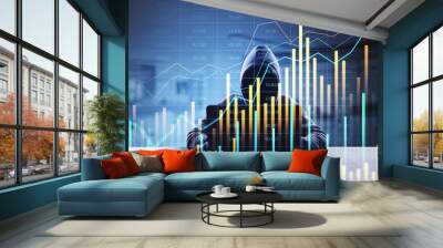 Hacker behind a laptop with financial data charts in the foreground, representing cybercrime in the financial sector. Wall mural