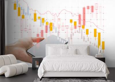 Hand holding smartphone with blank screen, overlaid with stock market candlestick chart, on white background. Concept of financial data and trading Wall mural