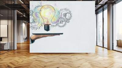 Hand holding tablet with light bulb Wall mural