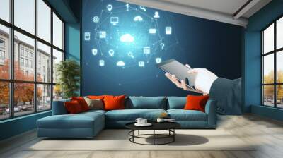 Hand using digital tablet with glowing social network icons Wall mural