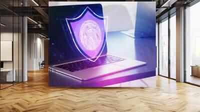 Laptop with a holographic fingerprint shield, on a desk with a bokeh background, symbolizing cybersecurity Wall mural