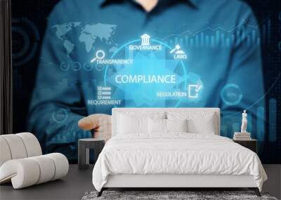 Man holding digital compliance interface with governance, transparency, and regulation icons floating over hands. Wall mural