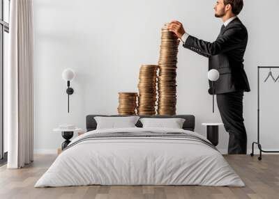 Man in formal attire stacking coins in ascending order on a white background, symbolizing financial growth and business success. Wall mural