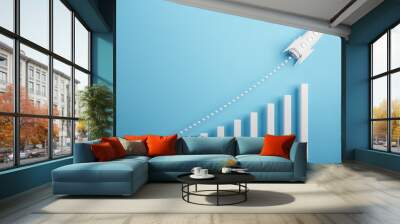 Startup and new project concept with white rocket flying up with dotted trajectory above light growth graph on blue background. 3D rendering Wall mural