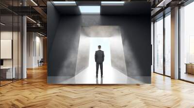 Thoughtful businessman in concrete office room interior standing at success door. New way, start up and innovation concept. Wall mural