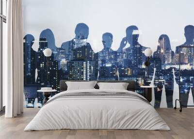 Wide image of business people silhouettes standing on abstract night city background. Teamwork and communication concept. Double exposure. Wall mural