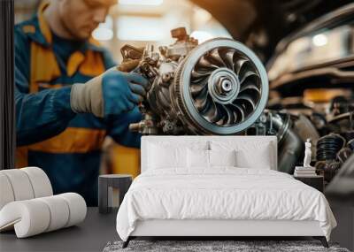 A dynamic image of an auto mechanic holding a new turbocharger, performing a quality inspection before installation in a vehicle.  Wall mural