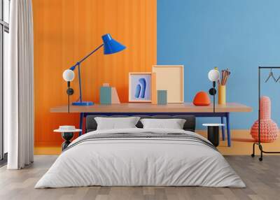 A high-resolution photograph of a blue desk featuring modern accessories against a solid color wall; the minimalistic decor includes a blue table lamp, empty frames Wall mural