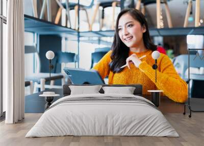 asian female smart entrepreneur sit working use tablet device stock manage and checking product inventory in furniture showroom,asian woman smiling cheerful business owner work in furniture store Wall mural