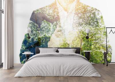 double exposure of businessman in suit and old tree in a green forest view from ground Wall mural