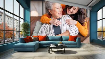 happiness asian family candid of daughter hug grandparent mother senior elder mom cozy relax on sofa couch in living room,Beautiful family of mother and daughter together, hugging and kissing at home Wall mural