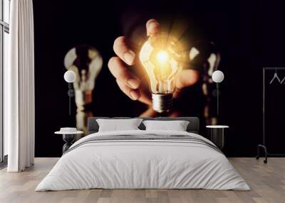 man hand choose glow light bulb creativity business ideas concept black background Wall mural