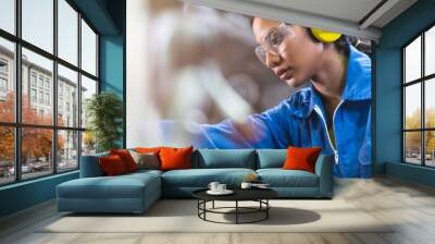 portrait asian female Professional engineering wearing uniform and safety goggles Quality control, maintenance, monitor screen checking process in factory, warehouse Workshop for factory operators Wall mural