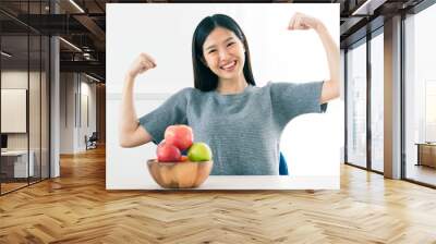 strong healthy asian beautiful woman hand show fresh fruit apple with action fit and firm posing healhty food diet ideas concept Wall mural