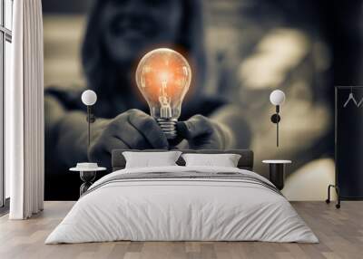 woman hand hold light bulb education creativity ideas concept Wall mural