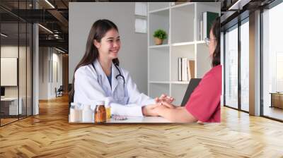 An Asian female doctor is consulting a patient who comes to discuss taking medication for health care. and treat disease with medicine Wall mural