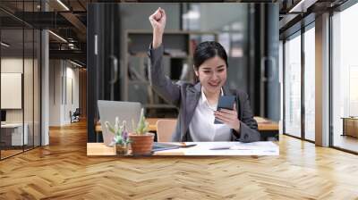 Asian business women are delighted and happy with their work on the phone and taking notes at the office. Wall mural