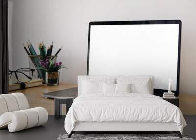 Cropped shot of simple workspace with blank screen laptop, stationery and copy space Wall mural