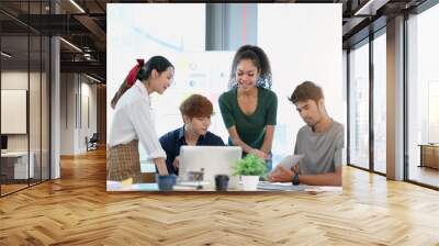 group of young asian business people in smart casual wear working together in creative office using  Wall mural