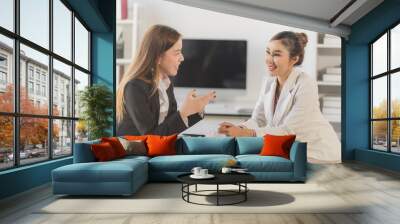 Two young Asian business woman talk, consult, discuss working with new startup project idea presentation analyze plan marketing and investment in the office. Wall mural