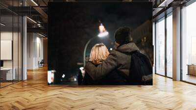 young couple enjoying new year's eve, fireworks in the background Wall mural