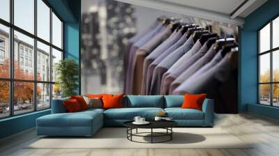 Row of men's suits hanging on hanger Wall mural