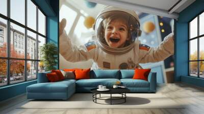 A young boy wearing a detailed astronaut suit, with his helmet and gloves clearly visible, as he jumps playfully in his bedroom.  Wall mural