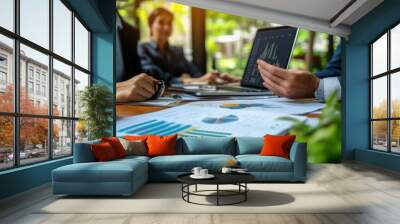 Business meeting with charts and data analysis on a table. Wall mural