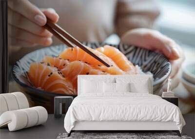 Close-up hand holding chopsticks to hold salmon sashimi. japanese food. generative AI image Wall mural