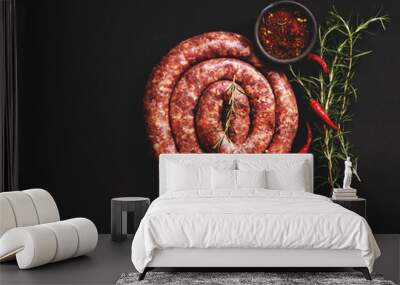 raw beef sausages on a cast-iron pan, selective focus Wall mural