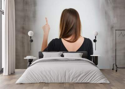 Woman index finger pointing up in back of the hand Wall mural