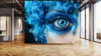 Azure Gaze: A captivating close-up of a woman's eye, adorned with mesmerizing blue makeup and surrounded by a swirling cloud of fluffy blue accents, evoking a sense of mystery and ethereal beauty.  Wall mural