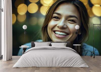 Portrait Of A Smiling Young Woman With Bright Eyes And Laugh Lines Radiating Joy And Warmth Against A Softly Lit Background Wall mural