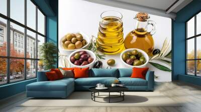 various types of olives and olive oil with assorted spices and olive leaves on white background Wall mural