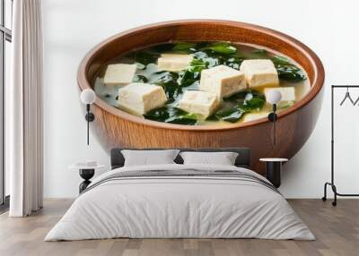 Wooden bowl of miso soup with tofu and seaweed on white background Wall mural