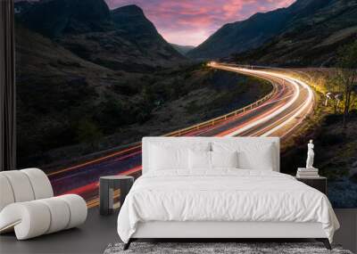 Car light trails on winding road through the highlands near Glencoe in Scotland at dusk Wall mural