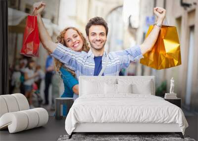 Happy Young Couple with Shopping Bags Wall mural