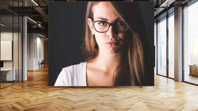 Pensive Young Woman on Dark Background Wall mural