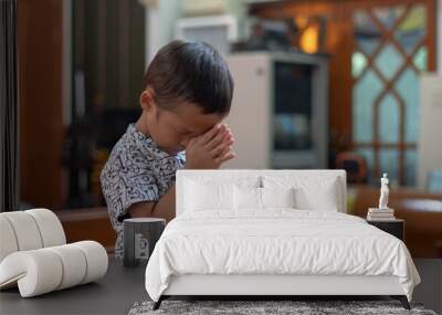 Little Christian Asian Boy Praying to God In worship room at church with Hope and Faith Wall mural