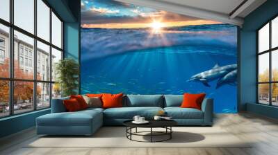 Beautiful tropical sea underwater background with traveling dolphins in blue water Wall mural