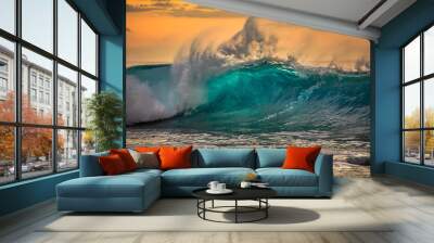 Green blue ocean splashing wave in front of orange sunset sky background Wall mural