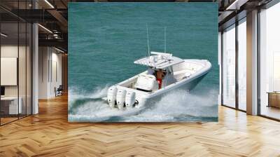 Open sport fishing boat powered by three outboard engines  Wall mural