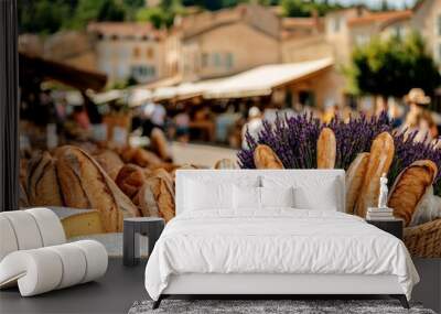 A bustling farmers market in Provence, with fresh baguettes, cheeses, and baskets of lavender, all set against the backdrop of a quaint village Wall mural