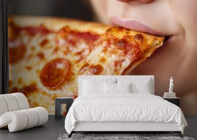 A close-up of a woman relishing a pizza slice, highlighting the textures and flavors of the crispy crust. Wall mural