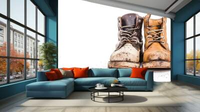 A pair of worn brown leather boots, placed side by side, isolated on a white background, showing scuffs and signs of wear Wall mural