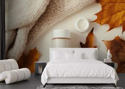 A soft autumnal glow highlighting skincare products among cozy sweaters and leaves, emphasizing the transition to richer, more nourishing skincare for fall. Wall mural