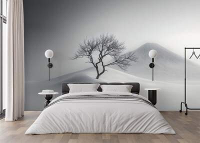 Solitary Tree Stands Amidst Misty Mountain Landscape in Monochrome Winter Scene Wall mural