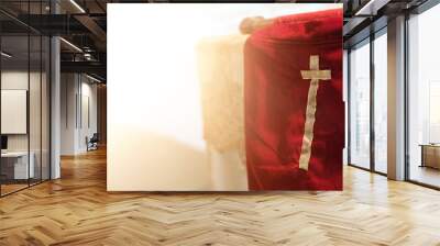 Offering red fabric bag with gold cross in church with natural flare light, with blank copy space Wall mural