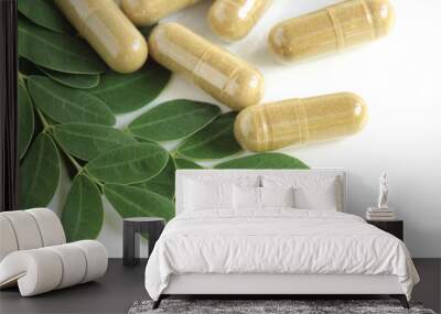 moringa oleifera capsule with green fresh leaves on white backgr Wall mural