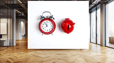 Classic alarm clock and red piggy bank on a white background. Wall mural